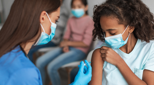 nurse giving shot to child